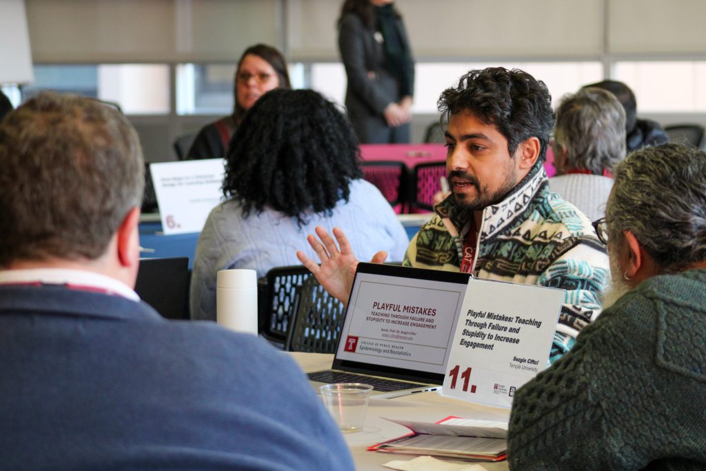 Man presenting with laptop at small table for lightning talk 11