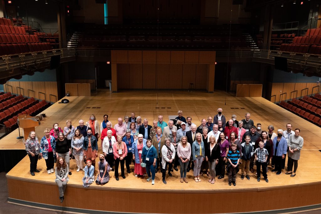 Group photo of church members on performing arts center stage.