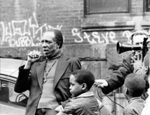 Father Paul Washington standing outdoors as the press record him.