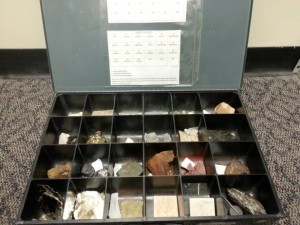Compartmentalized box holding various rock samples.