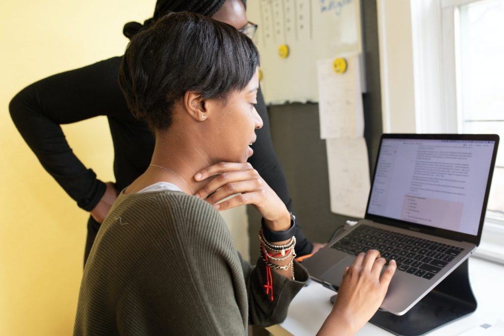 Photograph of woman in office looking at computer