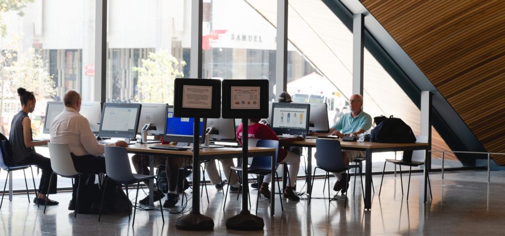 Photograph of patrons using the community computer lab in Charles Library