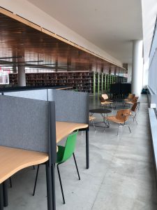 Photo showing seating inside Charles Library, with book stacks in the background