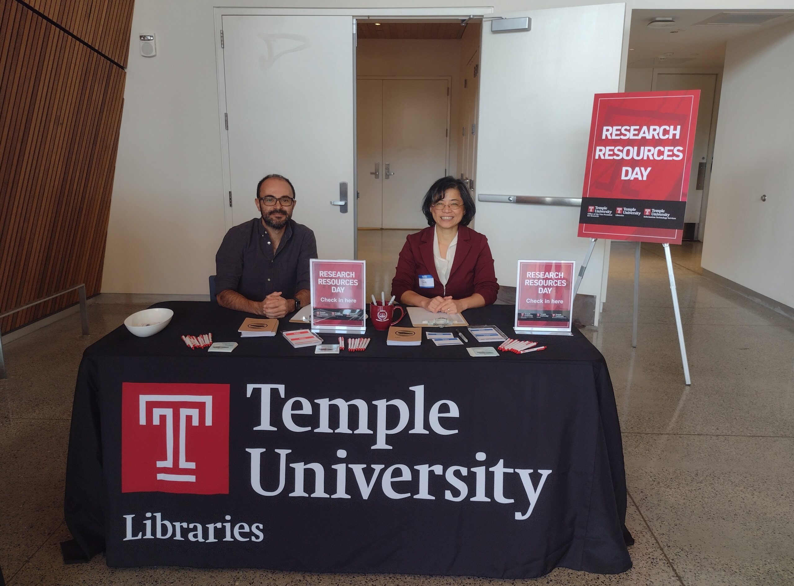 library staff at the welcome table at research resources day