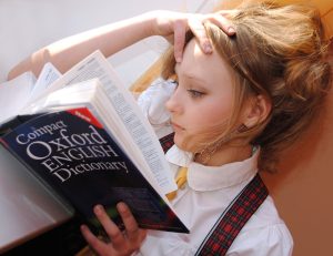 Girl reading the Oxford English Dictionary