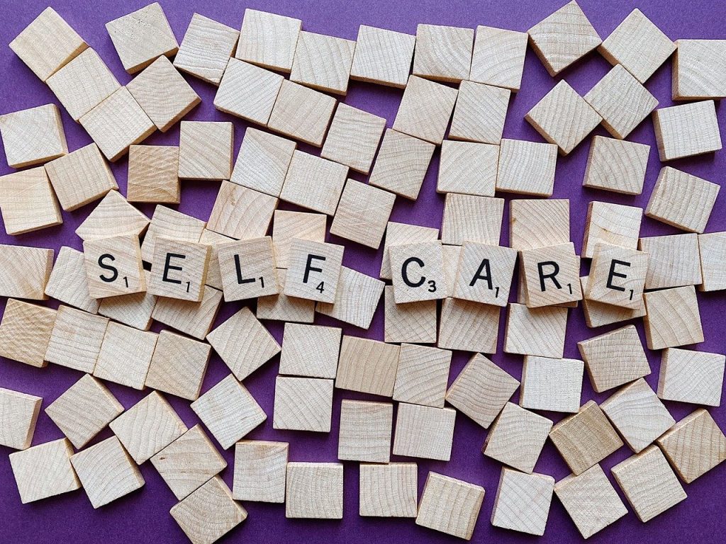 Scrabble pieces spelling out Self Care