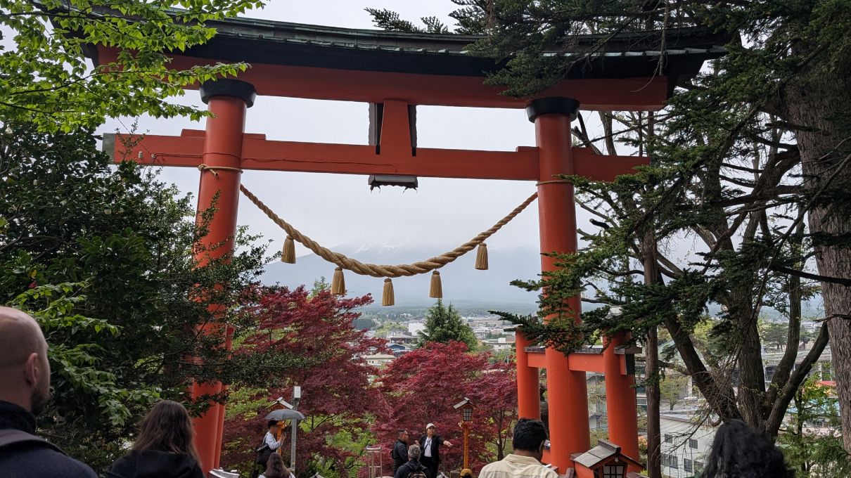 Shinto gate overlooking Mt Fuji obscured by clouds