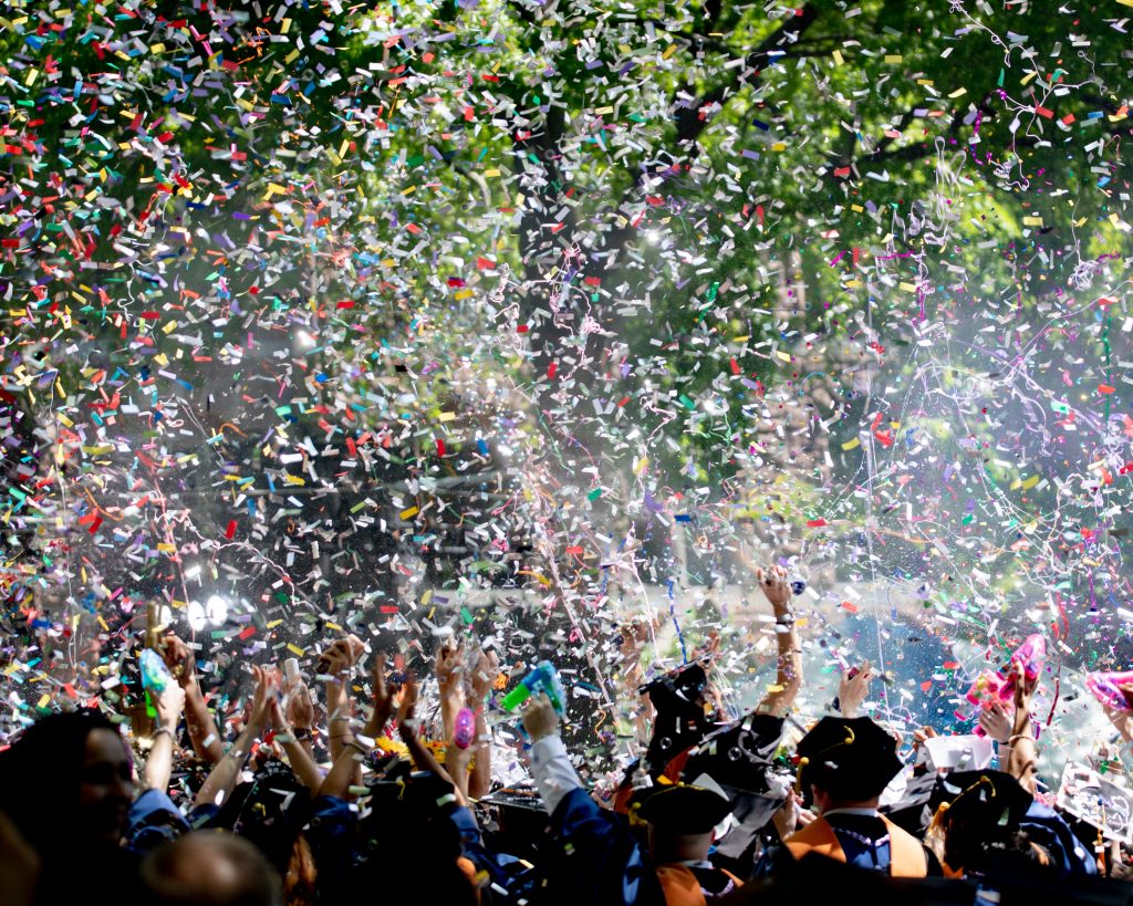 Graduate celebrating with confetti