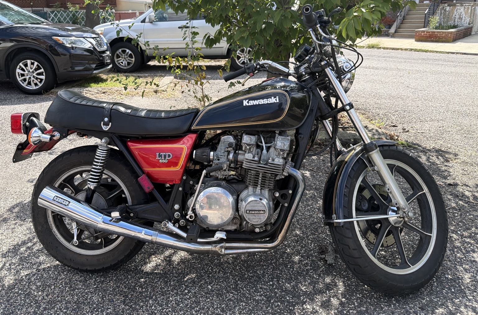 Lil' Beasty with its black and gold tank, original red side cover, and chrome Kerker exhaust.