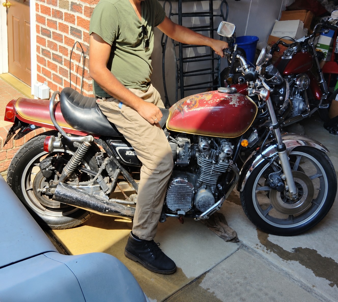 Zeshawn seated on Ol' Beasty, the weathered red 1976 Kawasaki LTD 900.