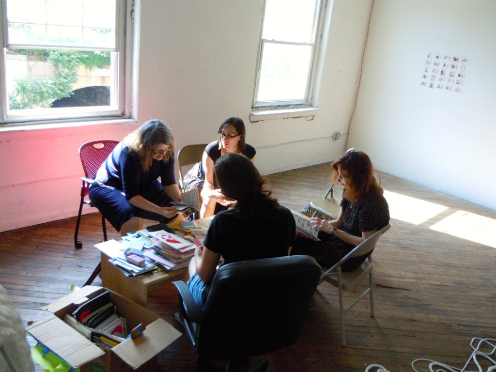 Librarians reviewing donor's zines.