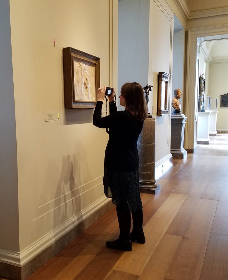 Image of Megan (the author) taking photos of works of art at the National Gallery of Art in Washington D.C.