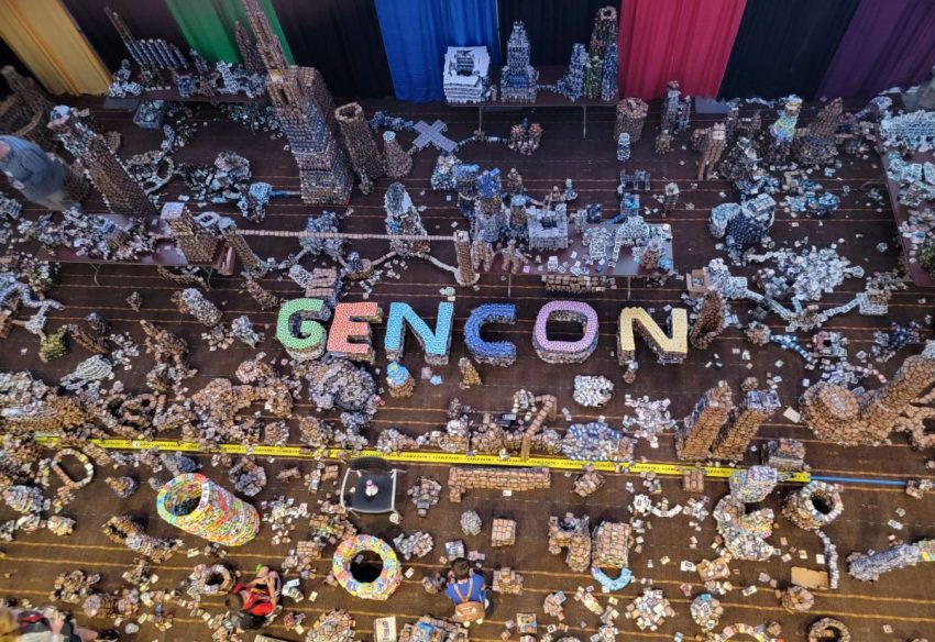 Towers of cards fill the floor at Gen Con with several of them spelling out GEN CON.