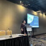 Dr. Sarah Bass presenting findings on attitudes towards genetic testing among diverse cancer populations at a symposium within the Society for Behavioral Medicine Conference, 2024