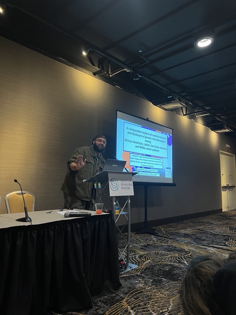 RCL Research Coordinator Caseem Luck presenting findings on attitudes towards genetic testing among diverse cancer populations at a symposium within the Society for Behavioral Medicine Conference, 2024