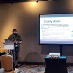 RCL Research Coordinator Caseem Luck presenting findings on attitudes towards genetic testing among diverse cancer populations at a symposium within the Society for Behavioral Medicine Conference, 2024